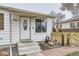 Front entrance with white door and landscaping at 1840 Rowena St, Thornton, CO 80229