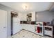 Galley style kitchen with white cabinets and granite countertops at 1840 Rowena St, Thornton, CO 80229