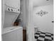 Bathroom with stacked washer and dryer, plus a toilet and black and white checkered floor at 4899 S Dudley St # 3A, Littleton, CO 80123