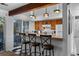 Kitchen featuring a breakfast bar with seating, wood cabinets, and modern appliances at 4899 S Dudley St # 3A, Littleton, CO 80123