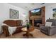 Inviting living room with brick fireplace, flat screen TV and comfortable seating at 4899 S Dudley St # 3A, Littleton, CO 80123