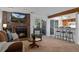 Inviting living room with brick fireplace and views through sliding glass doors to the outside at 4899 S Dudley St # 3A, Littleton, CO 80123