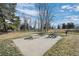 Outdoor picnic area featuring multiple tables, a grill, and trees at 4899 S Dudley St # 3A, Littleton, CO 80123