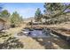 Spacious backyard with a lounge chair and patio seating area, ideal for relaxation and outdoor enjoyment at 6960 Choke Cherry Way, Littleton, CO 80125