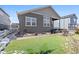 Home backyard with artificial grass and gray siding at 6956 S Titus St, Aurora, CO 80016