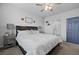 Bright bedroom with comfortable queen-sized bed, a ceiling fan and a bathroom at 6956 S Titus St, Aurora, CO 80016