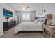 Bright bedroom featuring a dresser with TV and a well-lit window at 6956 S Titus St, Aurora, CO 80016