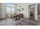 Charming dining room featuring a modern table setting, large windows, and hardwood floors at 6956 S Titus St, Aurora, CO 80016