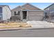 Charming two-story home featuring a two-car garage, landscaped yard, and inviting front porch at 6956 S Titus St, Aurora, CO 80016