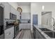 Modern kitchen featuring gray cabinets, stainless steel appliances, and a stylish backsplash at 6956 S Titus St, Aurora, CO 80016