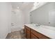 Bright bathroom featuring a shower-tub combination and modern vanity with a large mirror at 26789 E Cedar Ave, Aurora, CO 80018