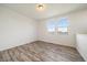 Bedroom with two windows, wood-look floors, and neutral-colored walls at 26789 E Cedar Ave, Aurora, CO 80018