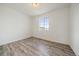 Neutral bedroom with wood-look floors and bright window at 26789 E Cedar Ave, Aurora, CO 80018