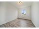 Bedroom with a window, wood-look floors and neutral walls at 26789 E Cedar Ave, Aurora, CO 80018