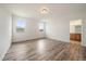 Bright bedroom with wood-look floors and a view to the en suite bathroom at 26789 E Cedar Ave, Aurora, CO 80018