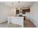Bright kitchen features a large island, modern appliances, stylish cabinets, and contemporary pendant lighting at 26789 E Cedar Ave, Aurora, CO 80018