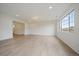 Large living room with new floors features a large window and easy access to other rooms at 26789 E Cedar Ave, Aurora, CO 80018