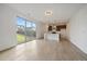 Open-concept living room and kitchen boasts lots of natural light and backyard views through large sliding glass doors at 26789 E Cedar Ave, Aurora, CO 80018