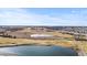 An aerial of a golf course and water feature, illustrating the expansive green spaces and scenic beauty of the area at 19543 E 54Th Ave, Denver, CO 80249