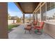 Covered back patio featuring patio furniture and a view of the backyard at 19543 E 54Th Ave, Denver, CO 80249