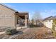 A covered back patio and landscaped yard add charm to the property, extending the living space outdoors at 19543 E 54Th Ave, Denver, CO 80249