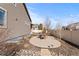 A backyard view with a concrete patio, showcasing the outdoor living space and landscaping of the property at 19543 E 54Th Ave, Denver, CO 80249