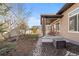 A covered patio, landscaped yard, and rock feature enhance the backyard, creating an inviting outdoor oasis at 19543 E 54Th Ave, Denver, CO 80249