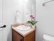 Bright bathroom showcasing a vanity with sink, flower decor, and large mirror at 19543 E 54Th Ave, Denver, CO 80249