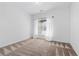 Well-lit bedroom showcases neutral carpeting and a sun-filled window with blinds at 19543 E 54Th Ave, Denver, CO 80249