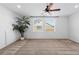 Large room with a ceiling fan, leafy green plant and multiple windows at 19543 E 54Th Ave, Denver, CO 80249