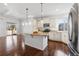 Spacious kitchen with stainless steel appliances, granite countertops, and modern lighting fixtures at 19543 E 54Th Ave, Denver, CO 80249