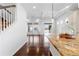 Bright kitchen featuring a granite island, white cabinetry, and dark wood floors at 19543 E 54Th Ave, Denver, CO 80249