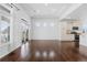 Open-concept living room featuring dark wood floors, light walls, and an exterior sliding glass door at 19543 E 54Th Ave, Denver, CO 80249