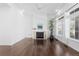 Living room featuring a fireplace, light walls, dark wood floors, and large windows for natural light at 19543 E 54Th Ave, Denver, CO 80249