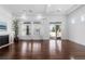 Spacious living room with a fireplace, light walls, dark wood floors, and large windows for natural light at 19543 E 54Th Ave, Denver, CO 80249