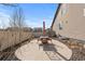 A backyard patio featuring a dining table with umbrella, perfect for outdoor gatherings and enjoying the fresh air at 19543 E 54Th Ave, Denver, CO 80249