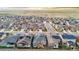 Expansive aerial view of a modern neighborhood with well-maintained homes against a scenic mountain backdrop at 17720 W 94Th Dr, Arvada, CO 80007