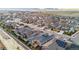 Scenic aerial view showcasing a suburban neighborhood with solar panels and mountain views in the distance at 17720 W 94Th Dr, Arvada, CO 80007