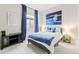 Comfortable bedroom featuring bright blue accents, carpet and a modern aesthetic at 17720 W 94Th Dr, Arvada, CO 80007