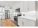 Modern kitchen showcasing white cabinets, stainless steel appliances, and a sleek backsplash for a clean, contemporary look at 17720 W 94Th Dr, Arvada, CO 80007