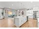 Open kitchen features a large island, stainless appliances, and flows into a patio for seamless indoor-outdoor living at 17720 W 94Th Dr, Arvada, CO 80007