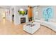 Cozy living room featuring a fireplace, TV, and comfortable seating at 17720 W 94Th Dr, Arvada, CO 80007