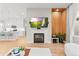 Open-concept living space with kitchen, dining, and living areas with modern fireplace and TV at 17720 W 94Th Dr, Arvada, CO 80007