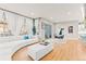 Spacious living room featuring a white sectional couch, hardwood floors, and natural light at 17720 W 94Th Dr, Arvada, CO 80007