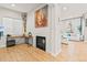 Bright living room featuring a fireplace, wood floors, and large windows at 17720 W 94Th Dr, Arvada, CO 80007
