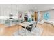 Open-concept dining and living area with modern furniture and hardwood floors at 17720 W 94Th Dr, Arvada, CO 80007