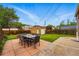 A spacious backyard features a large lawn, an outdoor seating area, and a detached garage at 3928 Zuni St, Denver, CO 80211