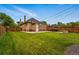 Well maintained backyard with green grass, a patio dining set, and privacy fence at 3928 Zuni St, Denver, CO 80211