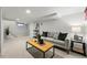 Finished basement with carpet flooring, modern decor, comfortable seating and a coffee table at 3928 Zuni St, Denver, CO 80211