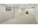 Spacious, finished basement with carpet flooring and a view to the renovated bathroom at 3928 Zuni St, Denver, CO 80211